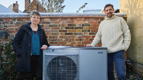 Photo of Dr Phil Grunewald and Dr Tina Fawcett with a heat pump