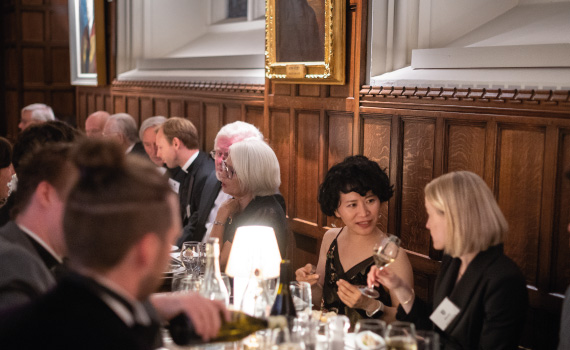 Women speaking at dinner in Oriel Hall