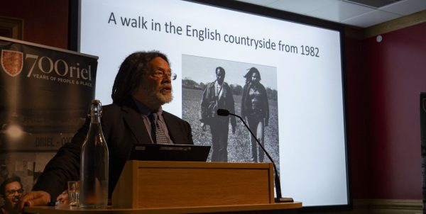 Paul Gilroy standing in the Harris Lecture Theatre at Oriel College giving the Rex Nettleford Lecture
